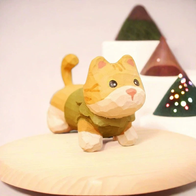 Yellow tabby kitten figurine in green sweater