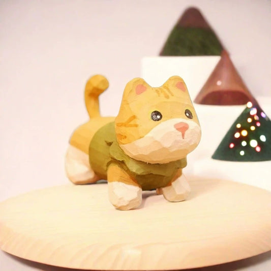 Yellow tabby kitten figurine in green sweater