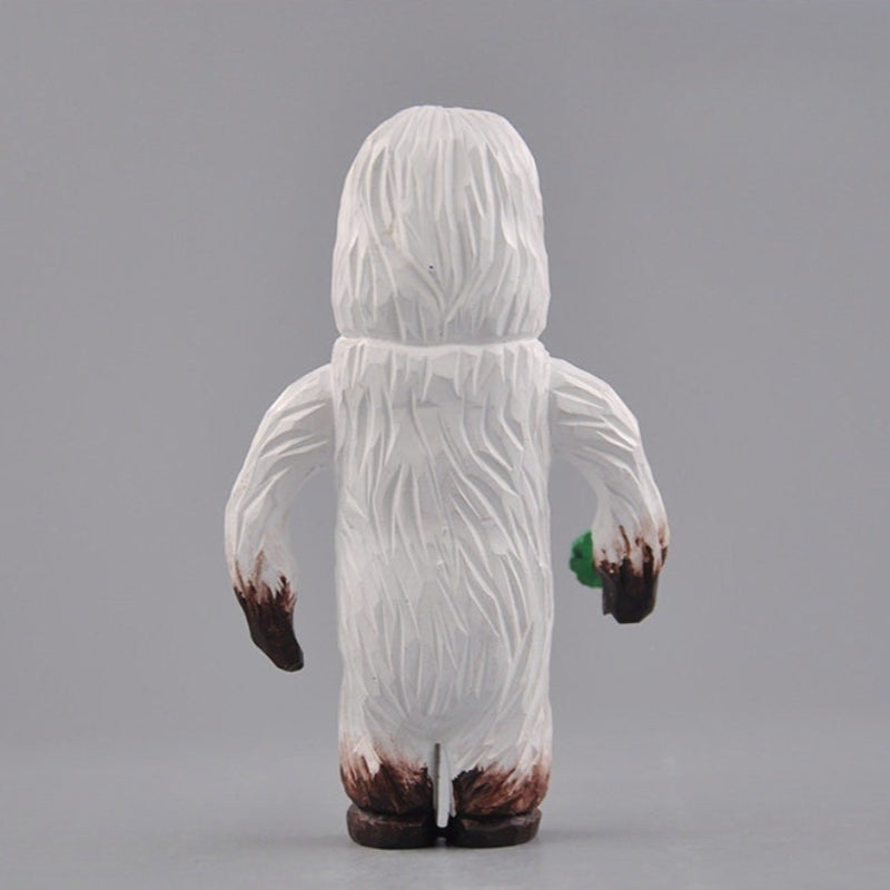Yeti figurine back view carved wooden texture