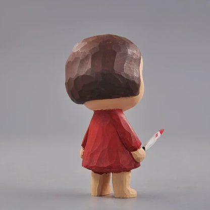 Rear view of the wooden girl figurine showing her brown bob and red dress