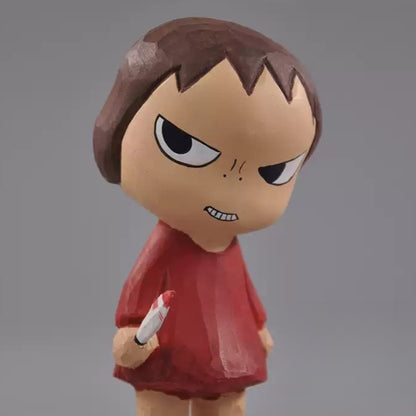 Close view of the wooden girl's oversized head, narrowed eyes, and toothy grin