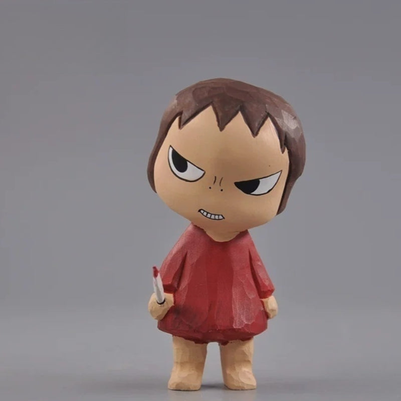 Front view of the wooden girl figurine in a red dress with a miniature knife