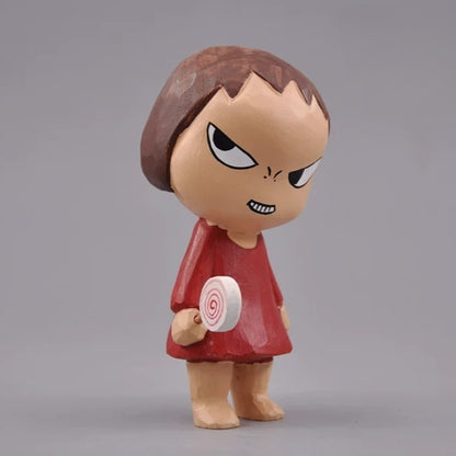 Wooden girl figurine in a red dress holding the spiral lollipop