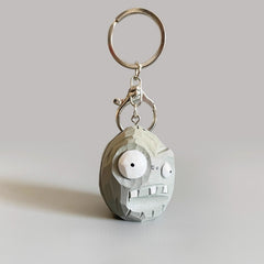 Hand-carved wooden Zombie Wall-nut keychain from Plants vs Zombies, shown on a plain gray background.