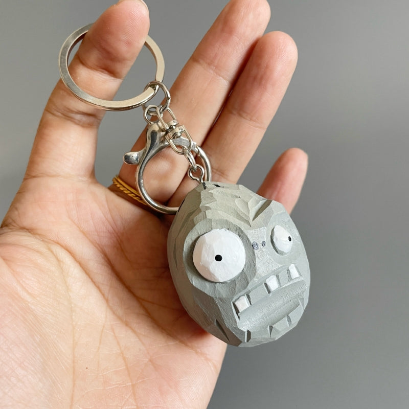 Plants vs Zombies Zombie Wall-nut wooden keychain held in hand, showing size and carved detail.