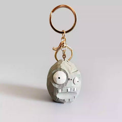 Front view of the handmade Zombie Wall-nut keychain with gold keyring, inspired by Plants vs Zombies.