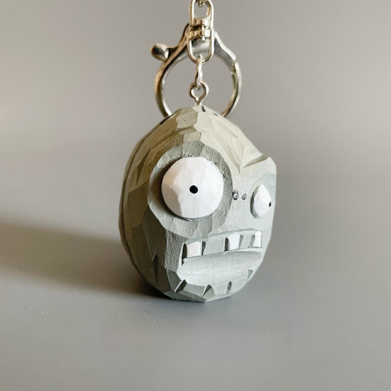 Front angle of the wooden Plants vs Zombies Zombie Wall-nut keychain highlighting its big eyes and expression.