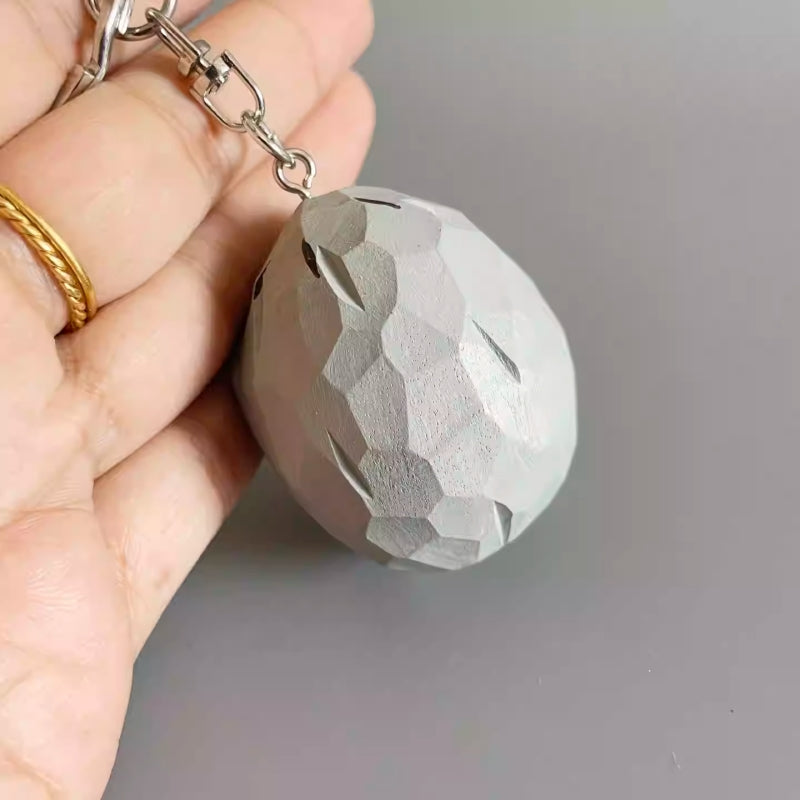 Back side of the Zombie Wall-nut keychain showing the natural wood carving patterns.